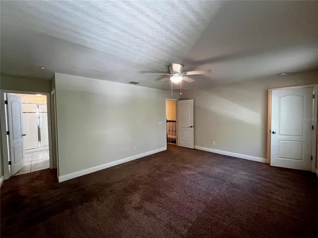 an empty room with wooden floor and closet area