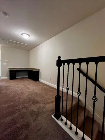 an empty room with a window and a ceiling fan