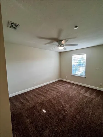 a bathroom with a granite countertop bathtub sink vanity and mirror