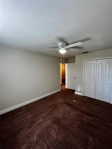 a bathroom with a granite countertop sink a mirror and a toilet
