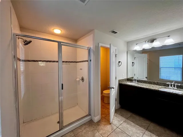 a view of a bathroom with a shower and a sink