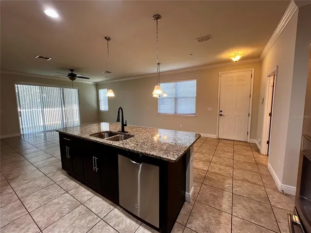 a spacious bathroom with a granite countertop sink a toilet a mirror and shower