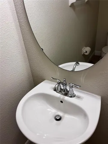 a bathroom with a sink and mirror