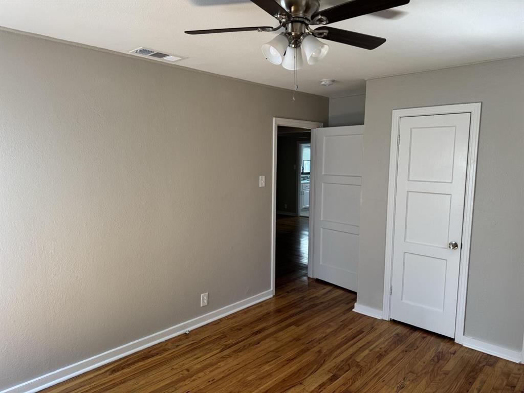 8427 Ridgelea Street Dallas, TX 75209 - Photo 2 of 17 a view of an empty room with wooden floor