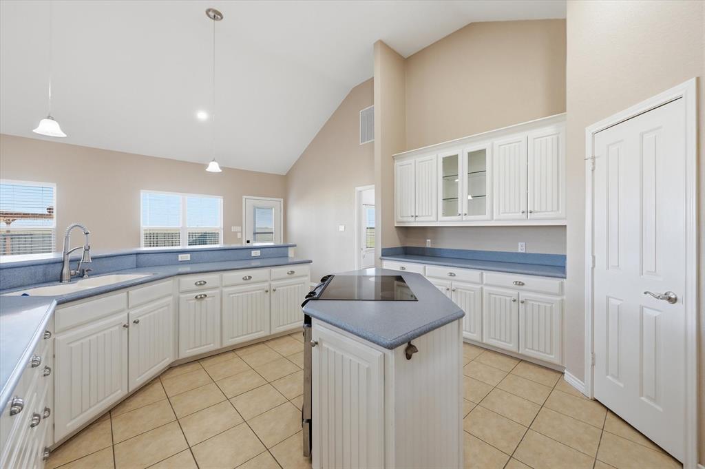 1616 Nash-Howard Road Waxahachie, TX 75165 - Photo 10 of 36 a kitchen with sink cabinets and chairs