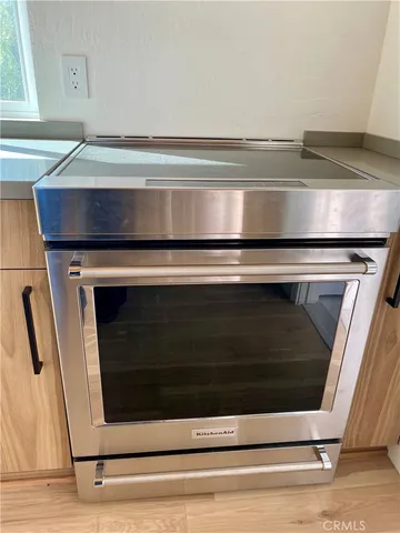 a stove top oven sitting inside of a kitchen