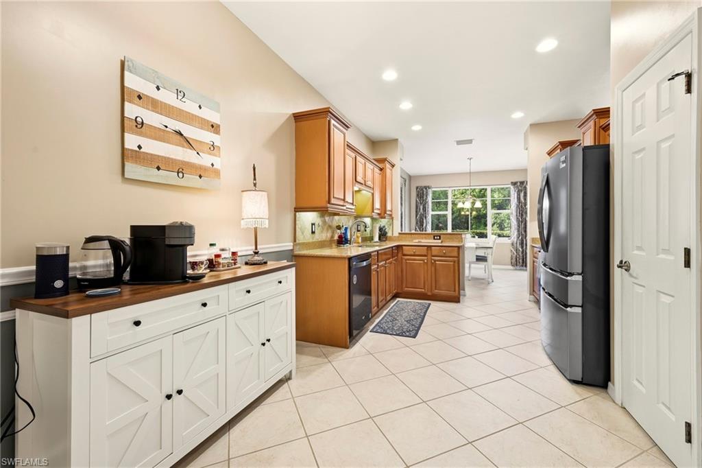 20674 Larino Loop Estero, FL 33928 - Photo 15 of 50 a kitchen with white cabinets and appliances