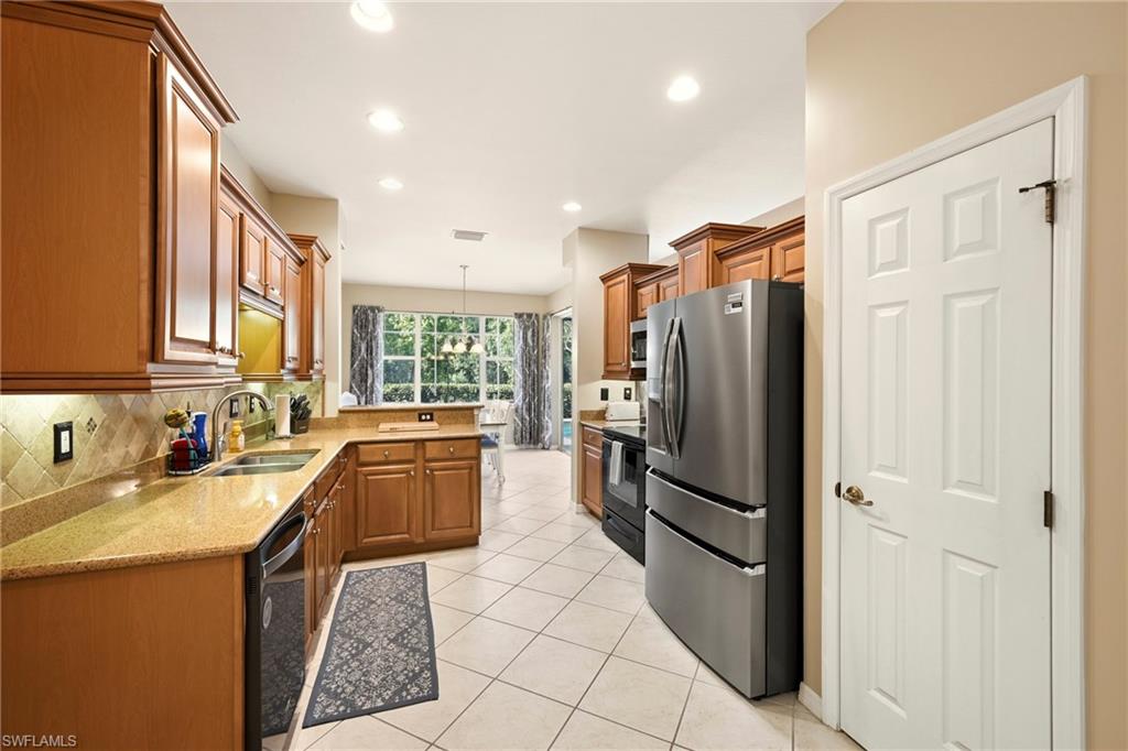 20674 Larino Loop Estero, FL 33928 - Photo 16 of 50 a kitchen with a refrigerator a sink and dishwasher