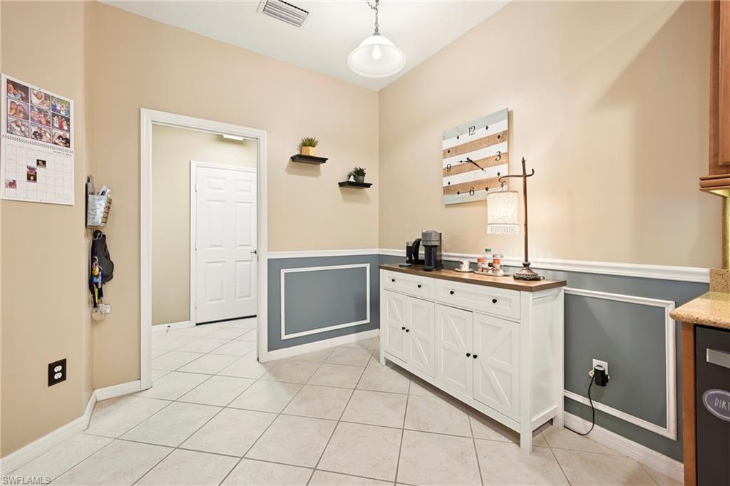 20674 Larino Loop Estero, FL 33928 - Photo 17 of 50 a kitchen with a refrigerator sink and cabinets