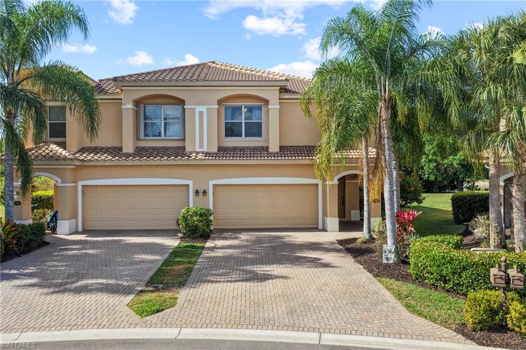 20674 Larino Loop Estero, FL 33928 - Photo 2 of 50 a front view of a house with a yard and garage