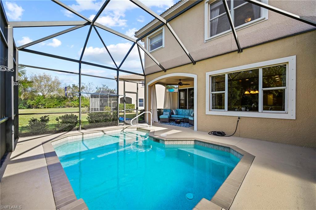20674 Larino Loop Estero, FL 33928 - Photo 22 of 50 a view of a patio with a table and chairs next to a yard