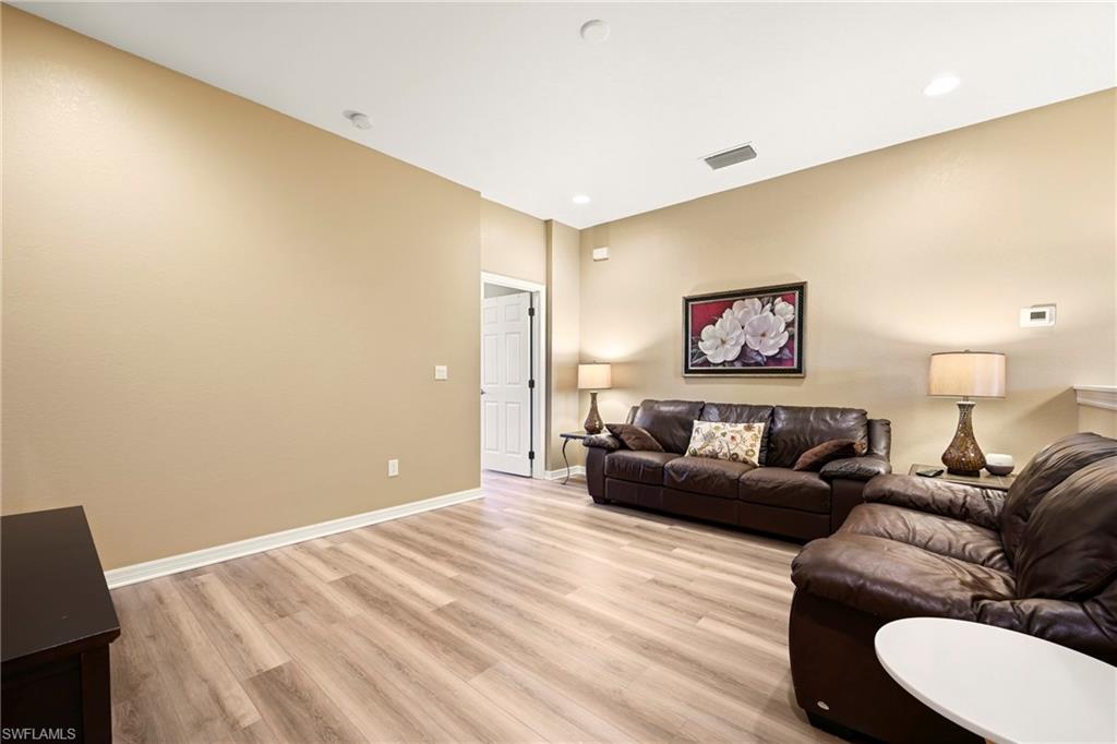 20674 Larino Loop Estero, FL 33928 - Photo 24 of 50 a living room with furniture and a wooden floor