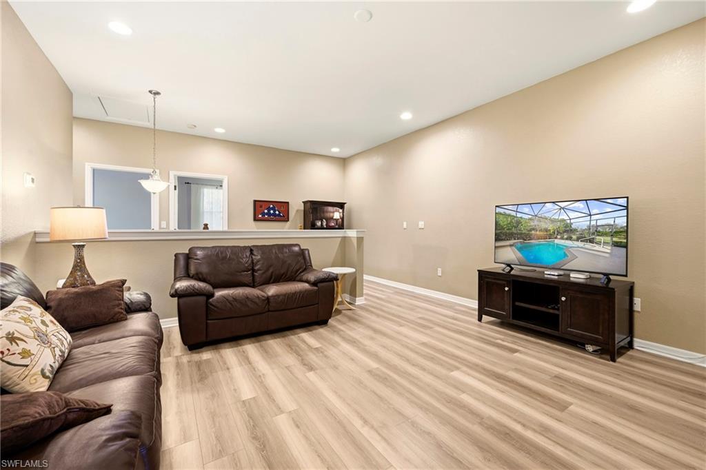 20674 Larino Loop Estero, FL 33928 - Photo 25 of 50 a living room with furniture and a flat screen tv