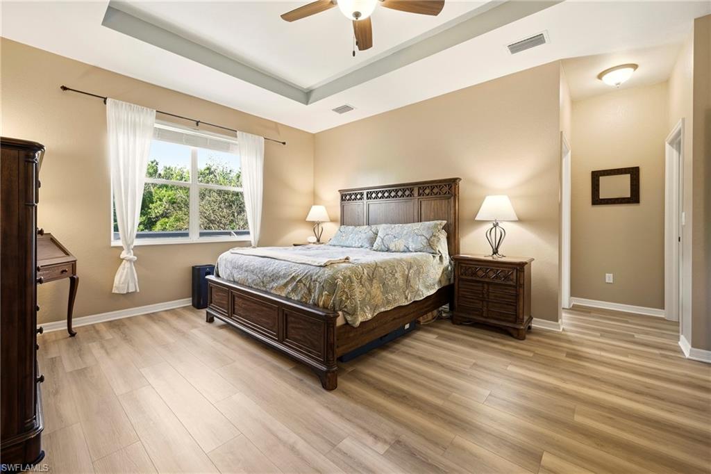 20674 Larino Loop Estero, FL 33928 - Photo 26 of 50 a bedroom with a bed lamp and a large window
