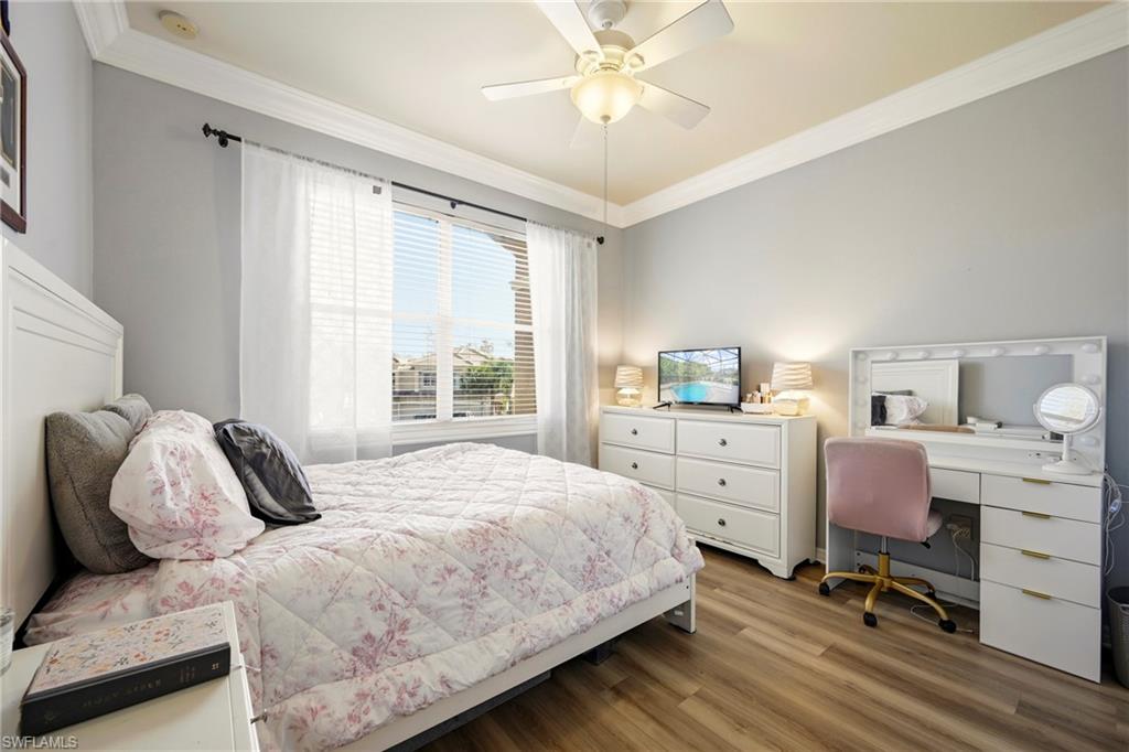 20674 Larino Loop Estero, FL 33928 - Photo 29 of 50 a bedroom with a bed and a chandelier