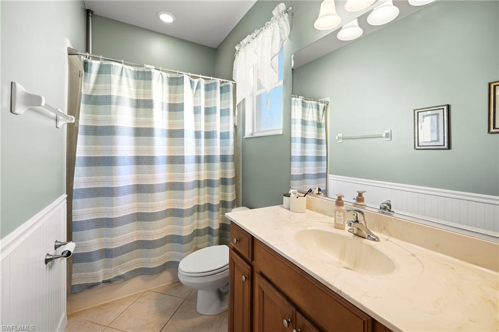 20674 Larino Loop Estero, FL 33928 - Photo 30 of 50 a bathroom with a sink a toilet a shower and a mirror