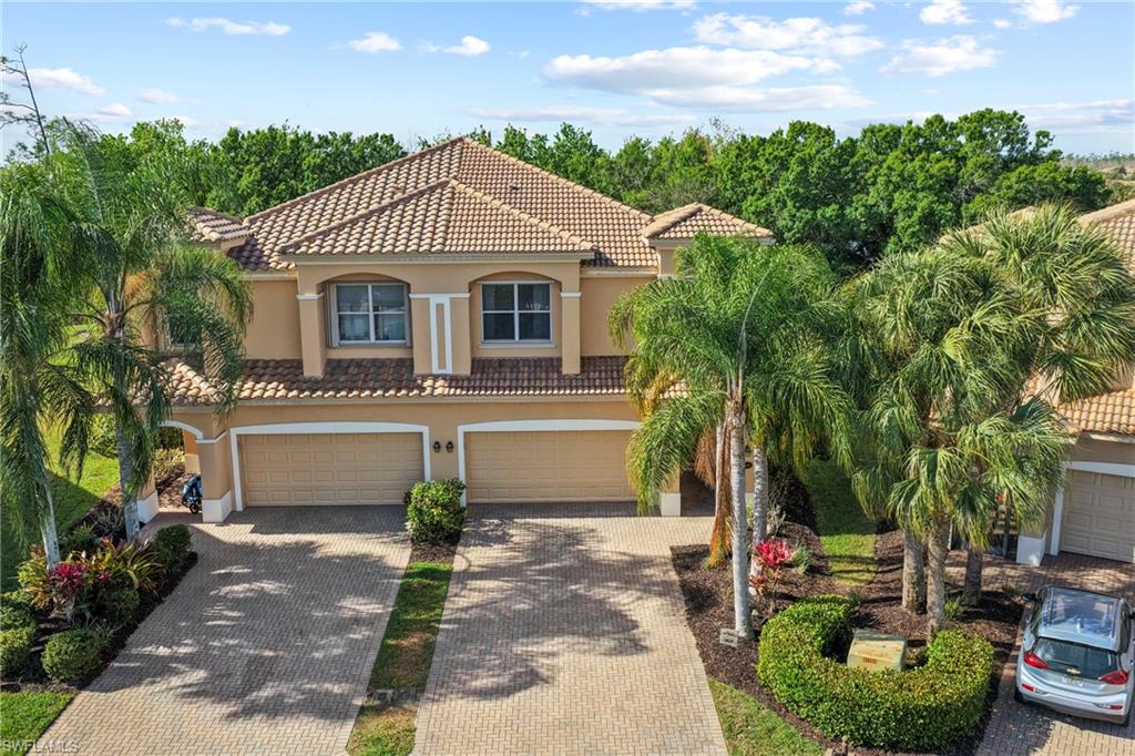 20674 Larino Loop Estero, FL 33928 - Photo 33 of 50 a front view of a house with garden