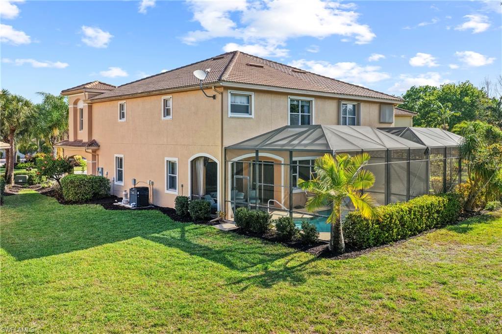 20674 Larino Loop Estero, FL 33928 - Photo 35 of 50 a front view of a house with garden