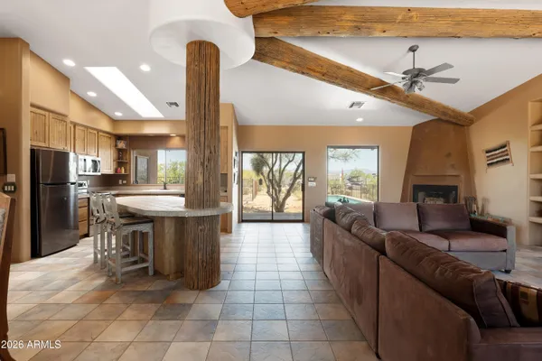 a kitchen with a large counter top space appliances and a chandelier