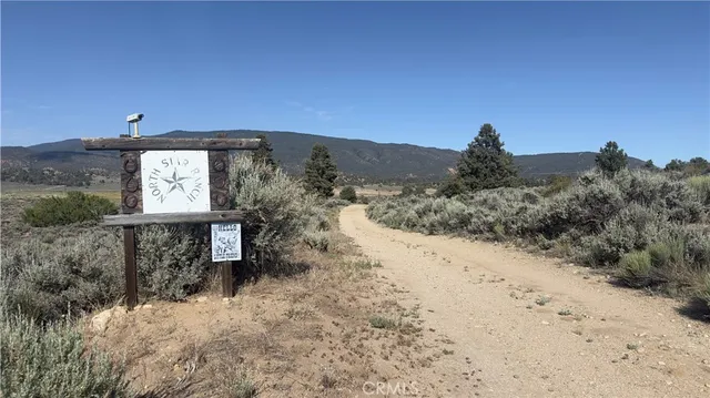 a view of a dry yard with a mountain