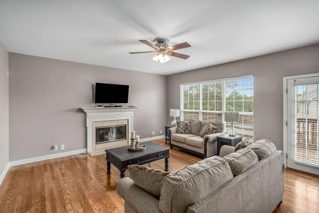 a living room with furniture a fireplace and a flat screen tv