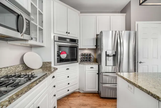 a kitchen with stainless steel appliances granite countertop a refrigerator stove and oven