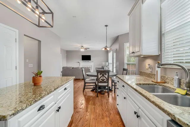 a kitchen with sink a counter and chairs