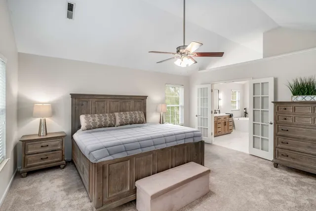 a bedroom with a bed and a chandelier