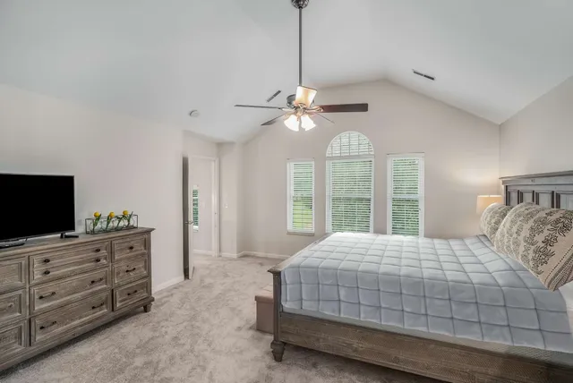 a bedroom with a large bed and a flat screen tv