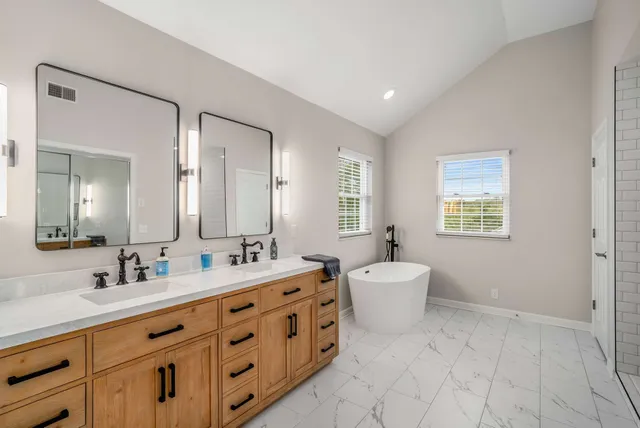 a bathroom with a double vanity sink a mirror and a