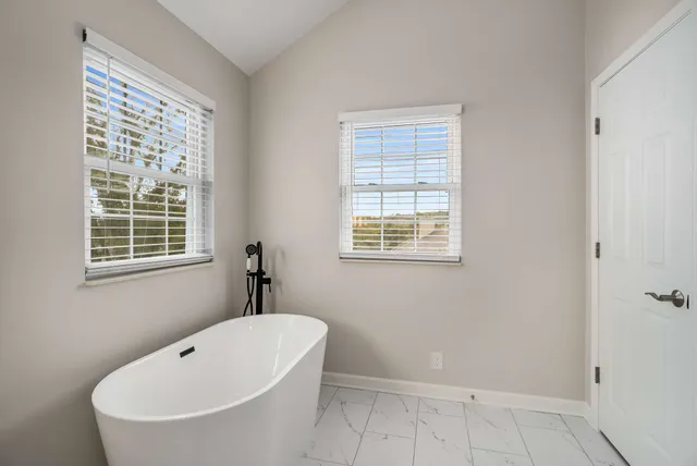 a bathroom with a bathtub and window