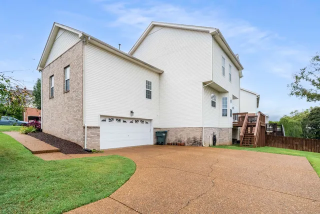 a view of a house with a yard and sitting area