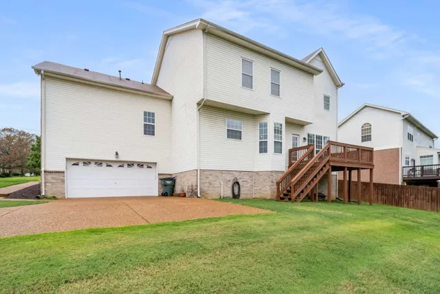 an aerial view of a house with a garden and trees