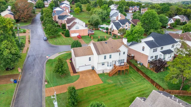 an aerial view of multiple houses with yard