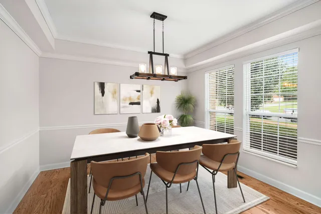 a view of a dining room with furniture window and wooden floor