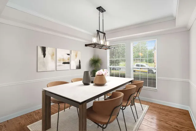 a view of a dining room with furniture window and wooden floor