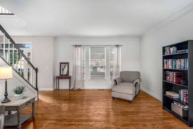 a living room with furniture and a book shelf
