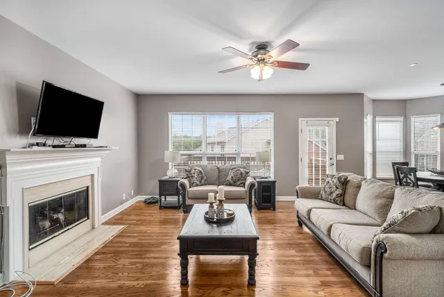 a living room with furniture a fireplace and a flat screen tv