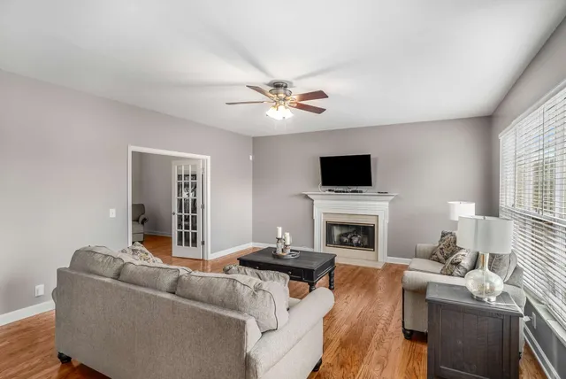 a living room with furniture a fireplace and a flat screen tv