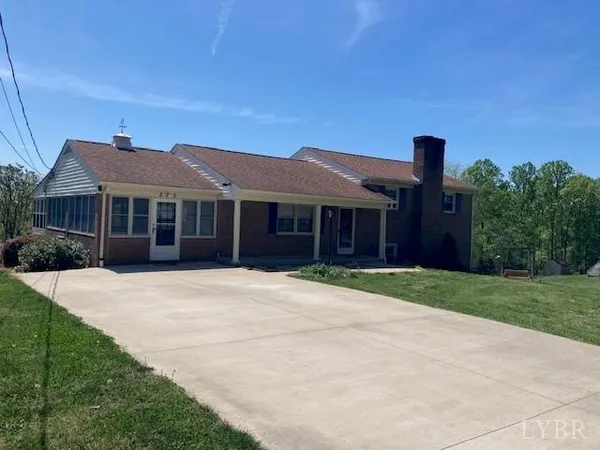 a front view of a house with a garden and yard