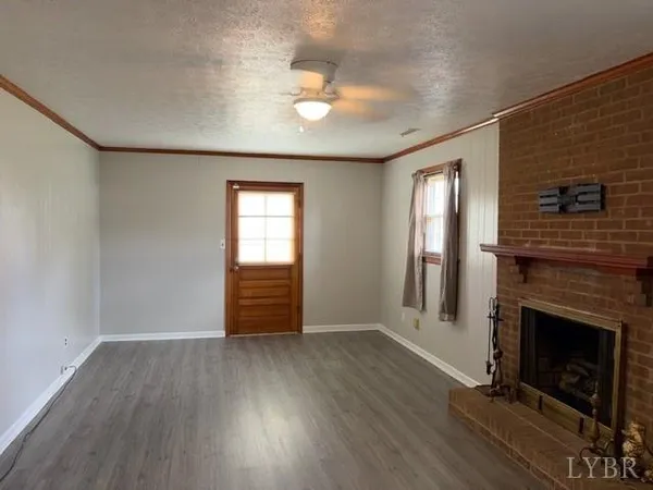 wooden floor in an empty room with a fireplace