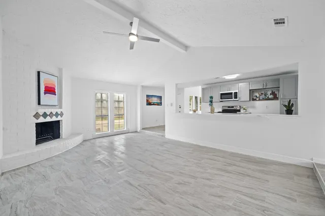 a view of a living room a kitchen with furniture and window