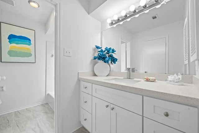 a bathroom with a sink a vanity and a mirror