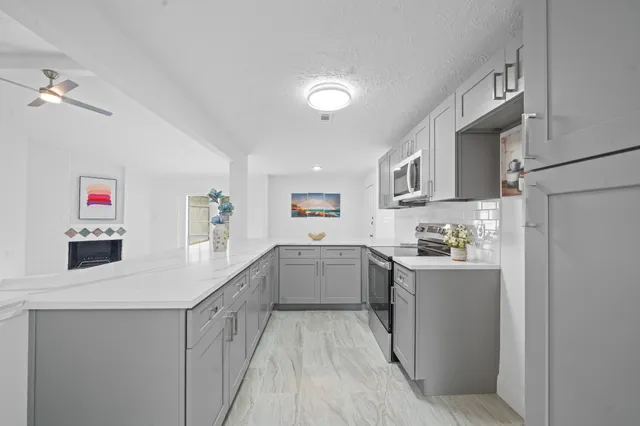 a kitchen with cabinets and wooden floor