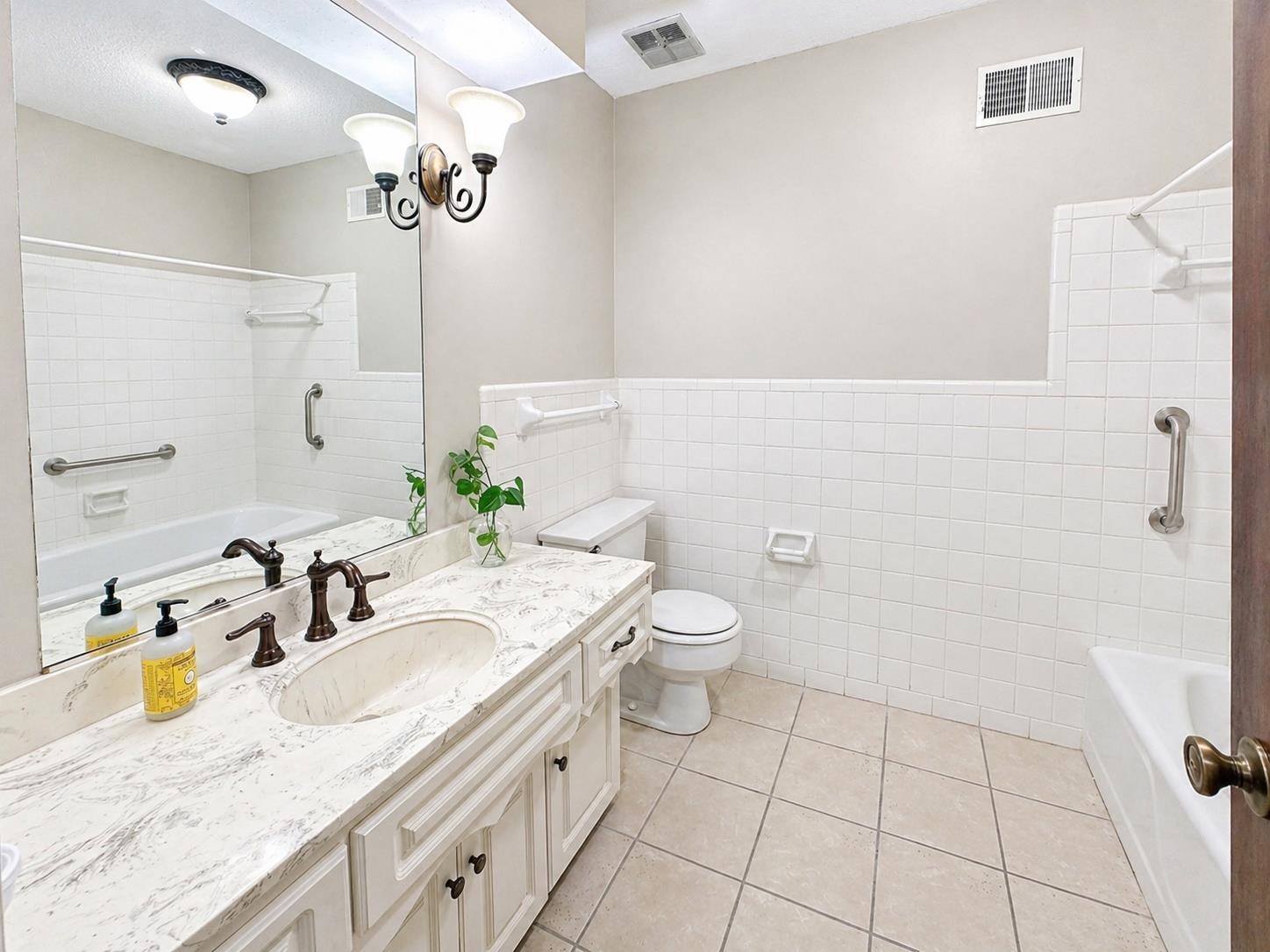 2148 Riverdale Road Germantown, TN 38138 - Photo 16 of 22 a bathroom with a granite countertop sink a toilet and a mirror