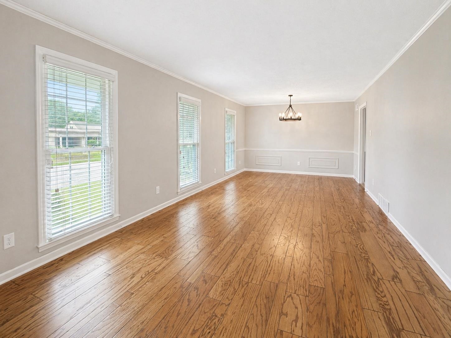 2148 Riverdale Road Germantown, TN 38138 - Photo 5 of 22 an empty room with wooden floor and windows
