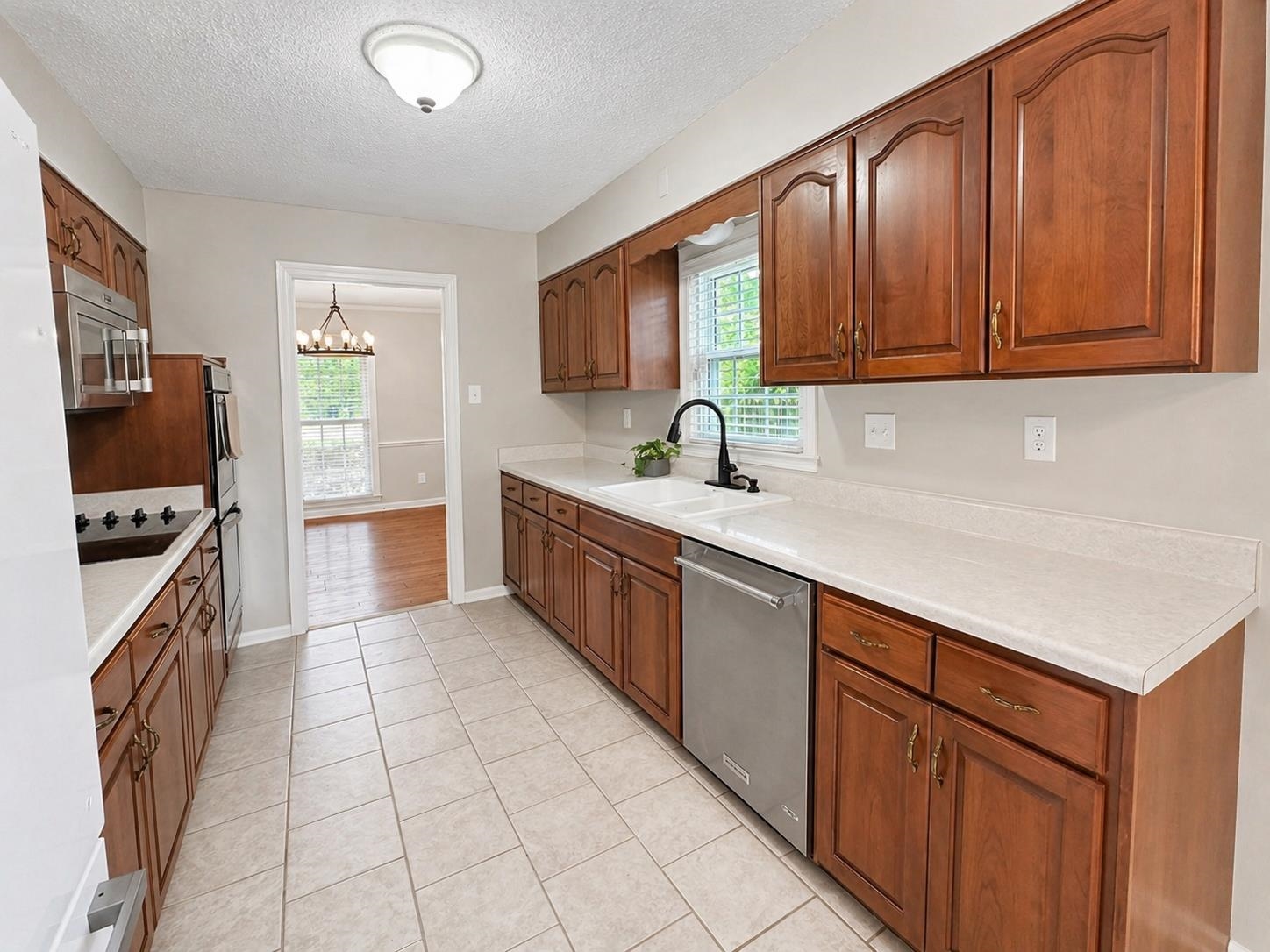 2148 Riverdale Road Germantown, TN 38138 - Photo 7 of 22 a kitchen with stainless steel appliances granite countertop a sink stove and cabinets