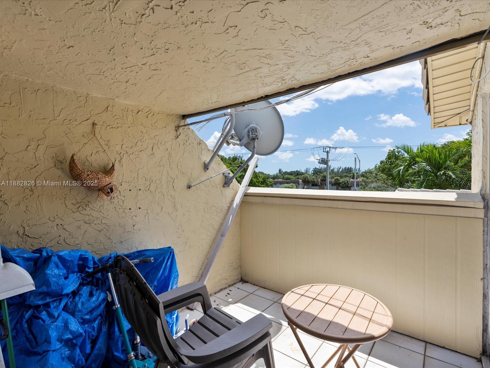 8401 West Sample Road, Unit 28 Coral Springs, FL 33065 - Photo 17 of 17 a view of a balcony furniture and a potted plant