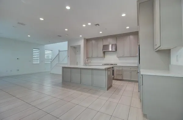 a kitchen with stainless steel appliances granite countertop a sink and a stove top oven