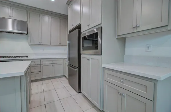 a kitchen with a sink stove and cabinets